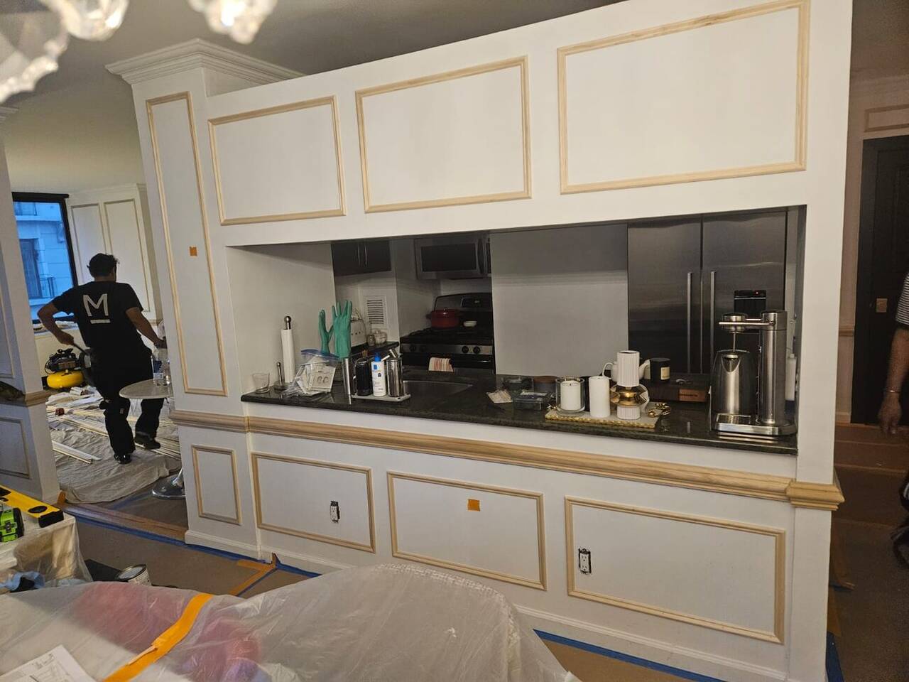 Custom kitchen cabinetry with mirrored backsplash